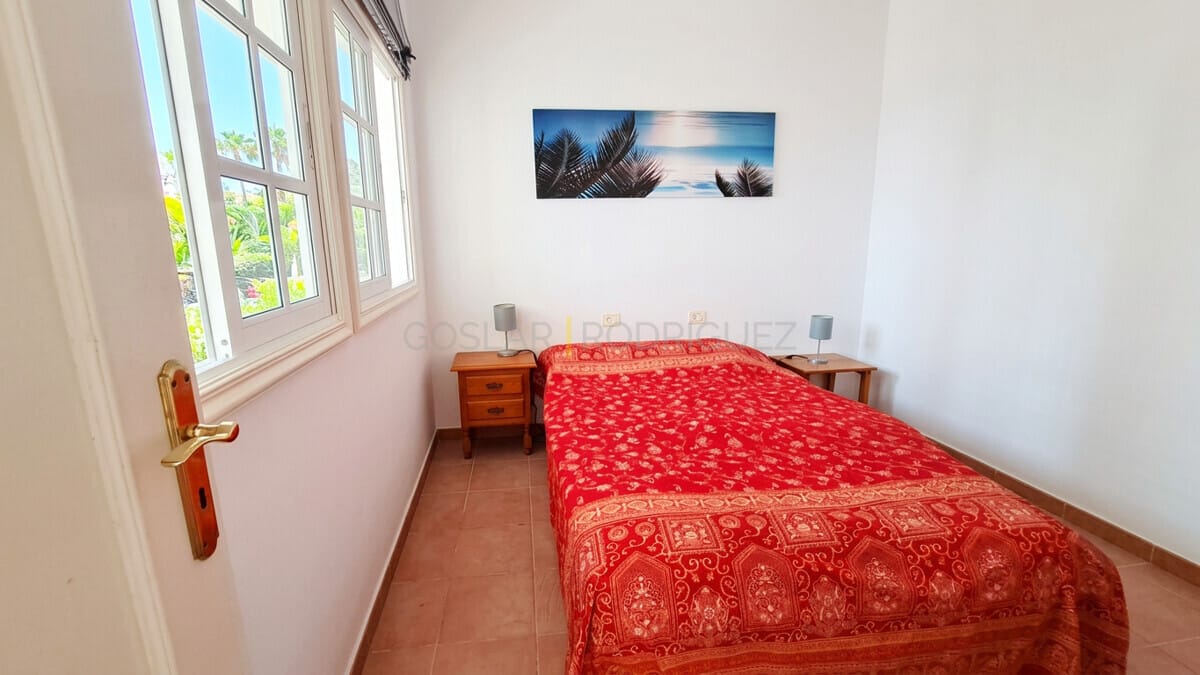 Cozy bedroom with bright windows and tropical art in Abades, Tenerife villa.
