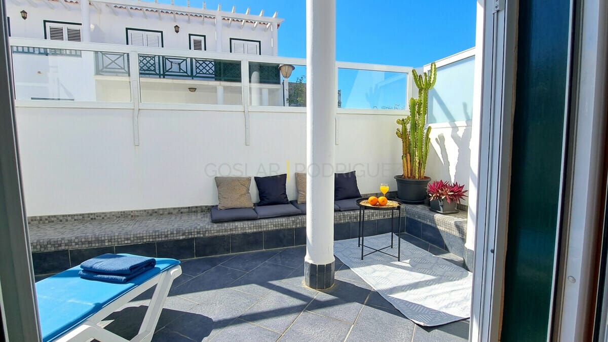 Relaxing outdoor space with sun lounger and built-in bench.