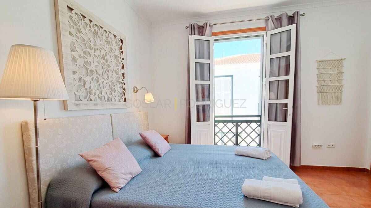 Bedroom with double bed, decorative headboard and balcony access in Abades, Tenerife villa.